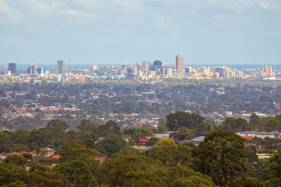 Adelaide city skyline beyond the suburbs and trees